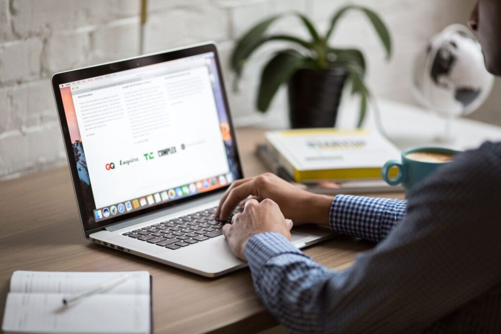 Writing blog content on a laptop at a desk