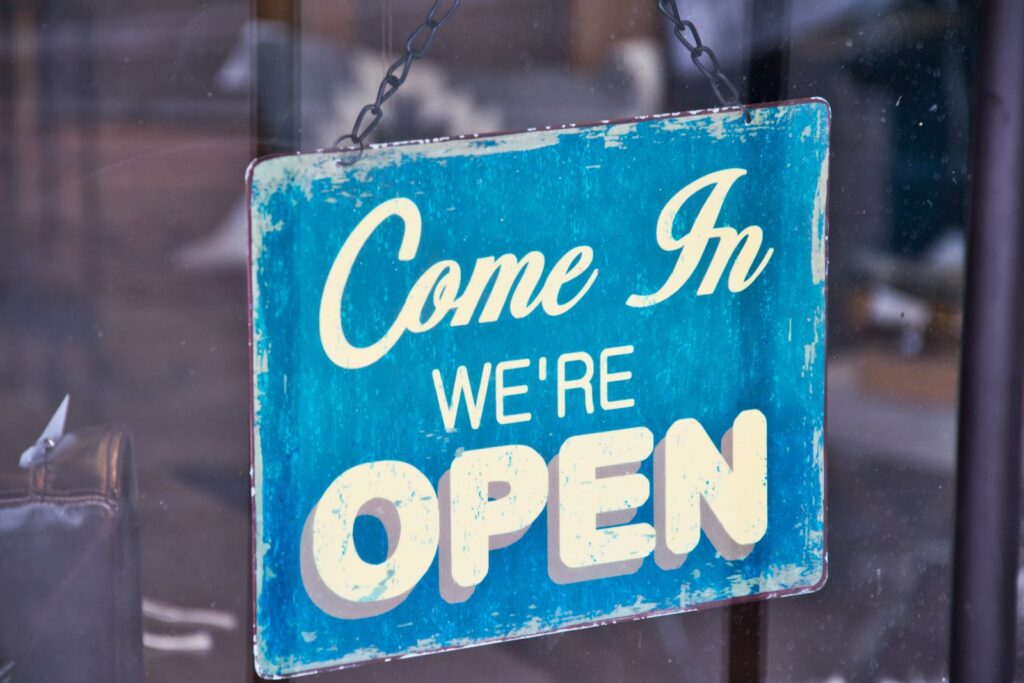 Open sign in a local business storefront window