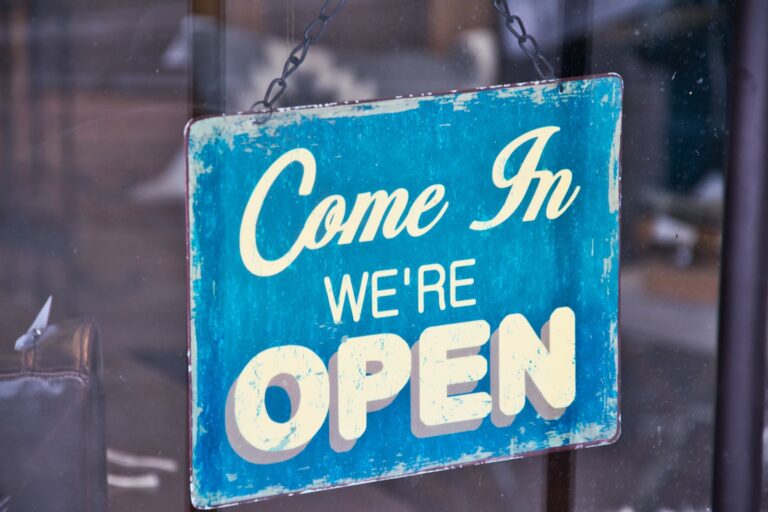 Open sign in a local business storefront window