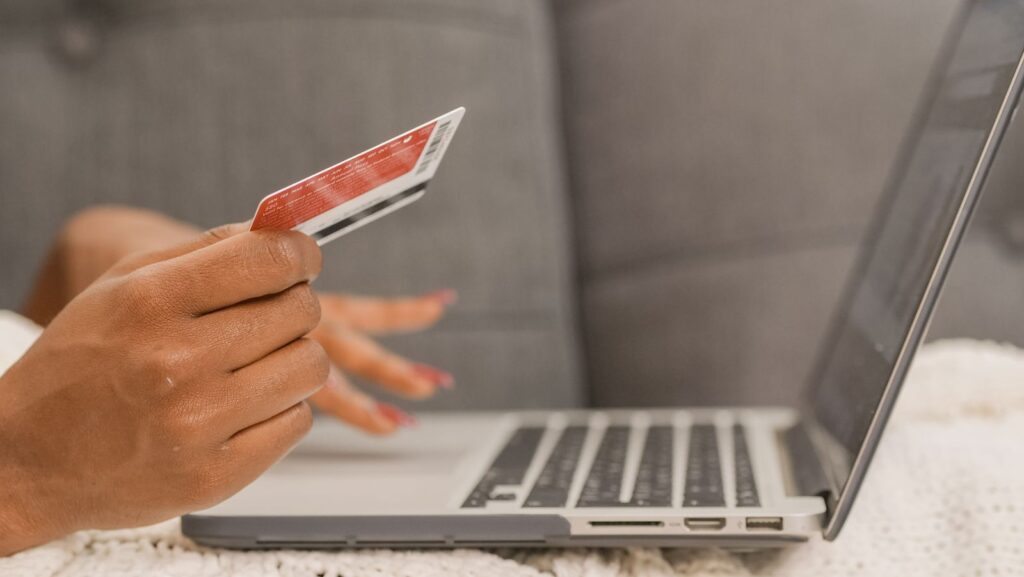 Online purchase with a credit card and laptop representing conversion rate optimization
