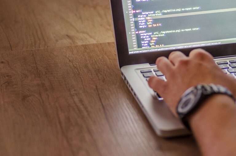 Web developer building a website on a laptop